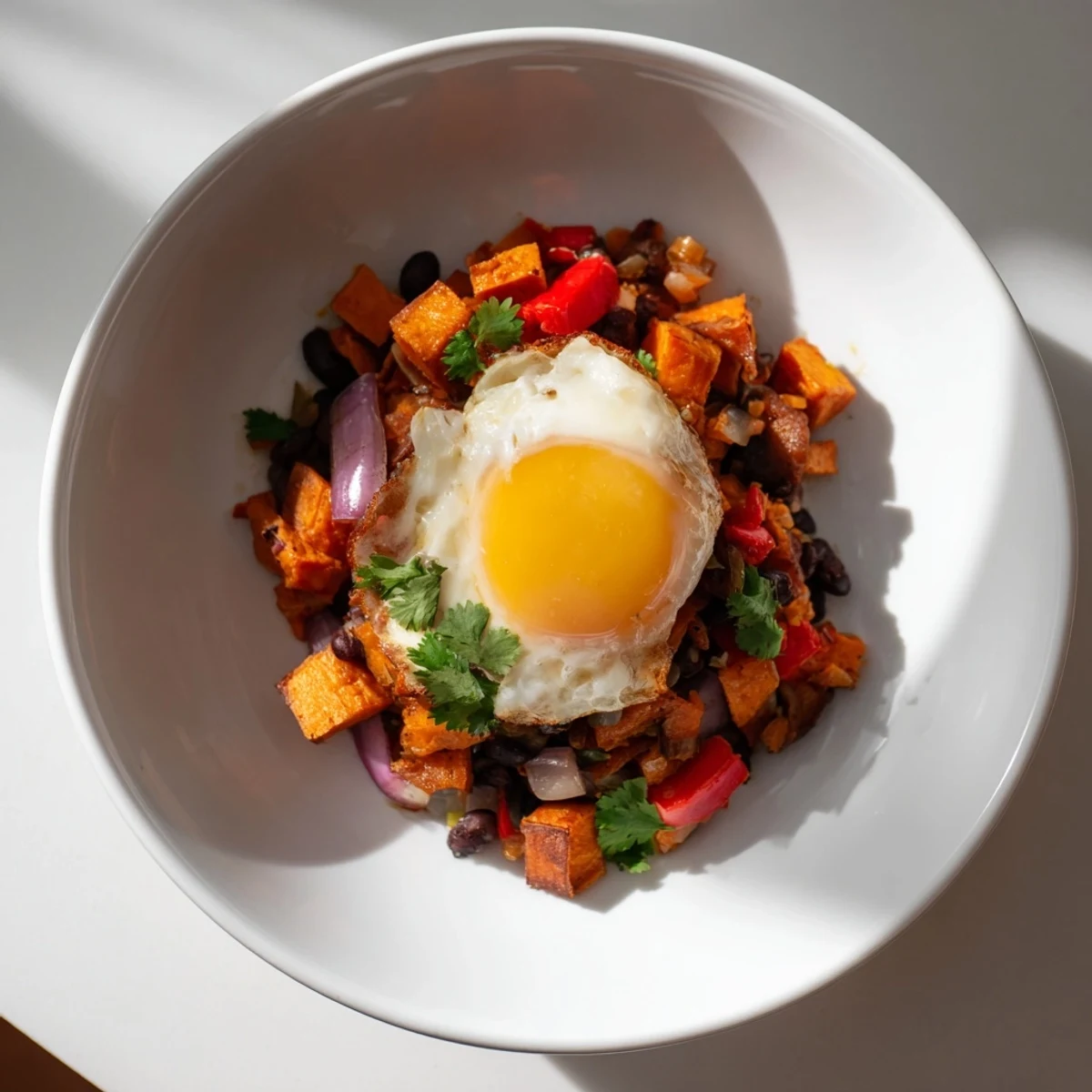 Fragrant Sweet Potato & Black Bean Breakfast Hash simmering in a skillet, brimming with colorful veggies and spices.