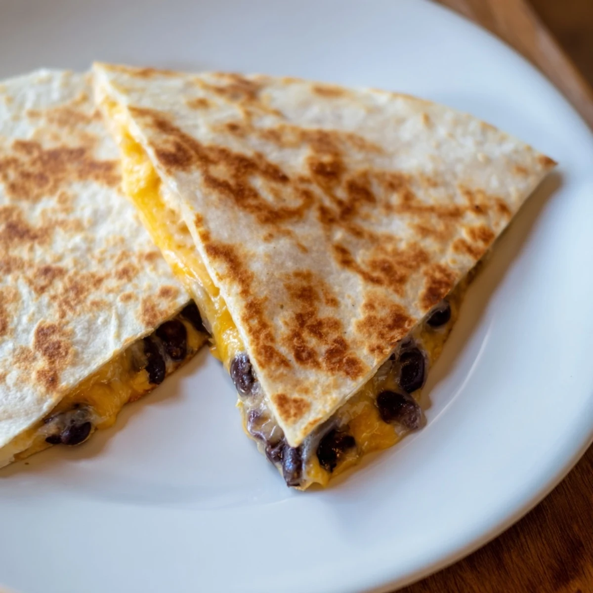 A stack of delicious quesadillas featuring melty cheese and savory beans, quick and easy to prepare.
