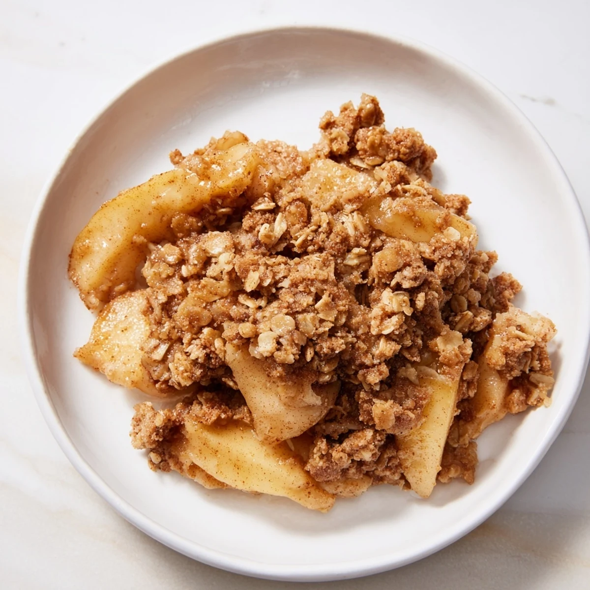 Deliciously baked Apple Crisp with a crispy oat topping, served warm and inviting.