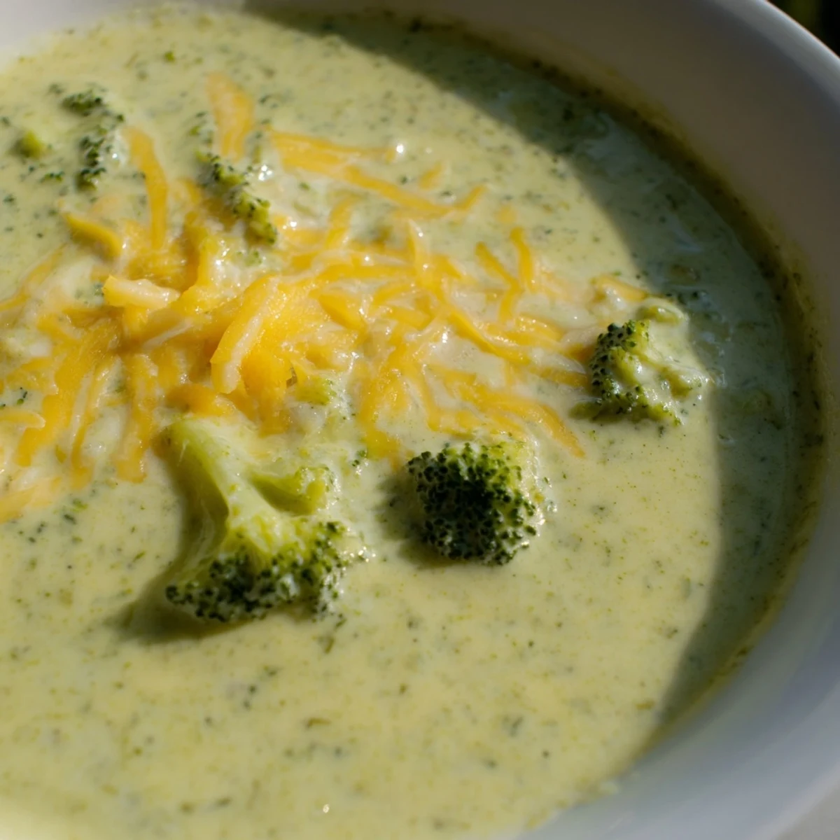 Hearty Broccoli Cheese Soup, a vibrant green soup filled with broccoli florets and golden cheese.