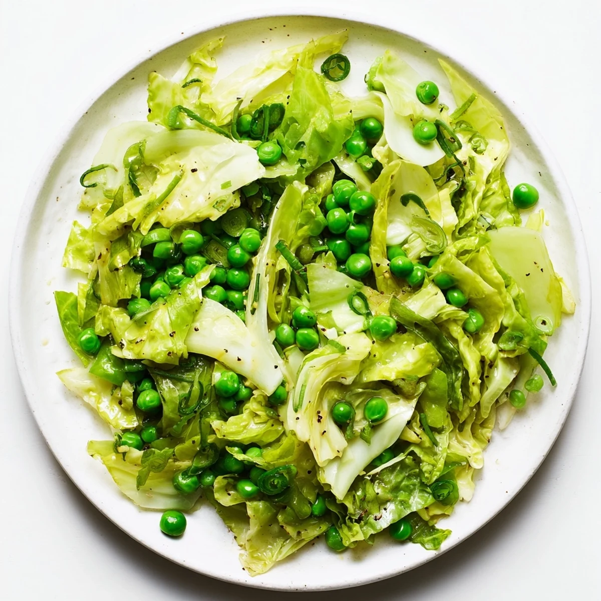 Vibrant cabbage stir-fry with garlic, soy, and peas, showcasing a delicious Asian-inspired side dish.