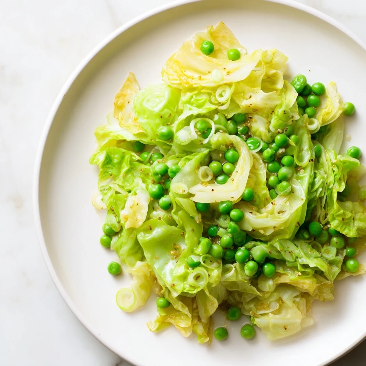 The garlic-kissed cabbage stir-fry with frozen peas, ready to serve over fluffy rice, looks delicious.