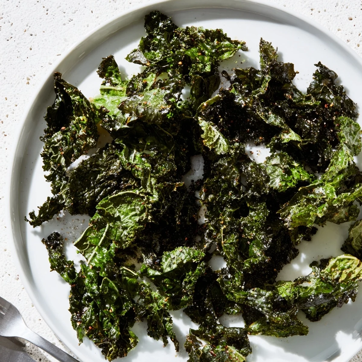 Golden, crispy Baked Kale Chips arranged on a baking sheet, ready for a delicious, healthy snack.