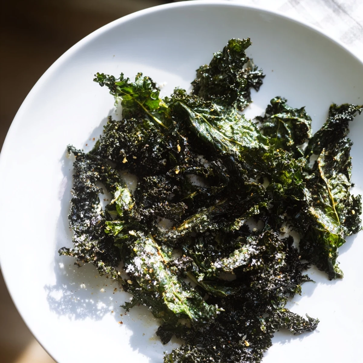Freshly baked, vibrant green Baked Kale Chips offer a crunchy, savory satisfaction for any craving.