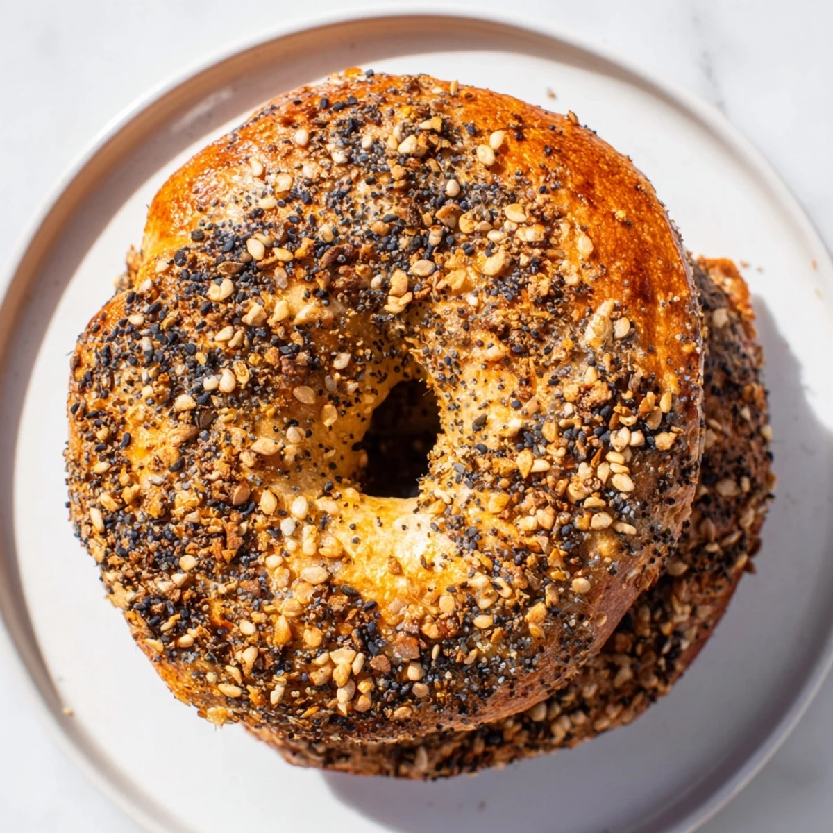 Fluffy, golden brown Homemade Budget Bagels, fresh from the oven, offering a delicious, warm aroma.