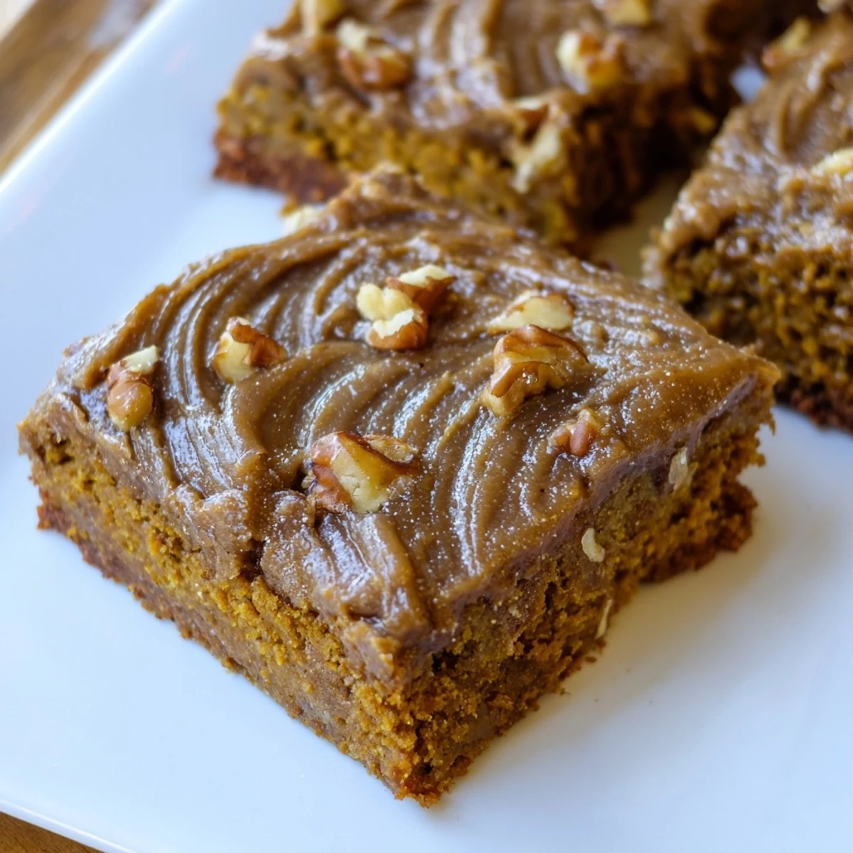 Freshly baked pumpkin bars, beautifully frosted for a delicious bite of fall flavors.