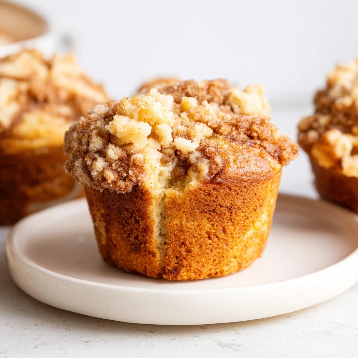 Lightened Christmas Coffee Cake Muffins, golden brown, with a streusel topping, perfect for a cozy morning.