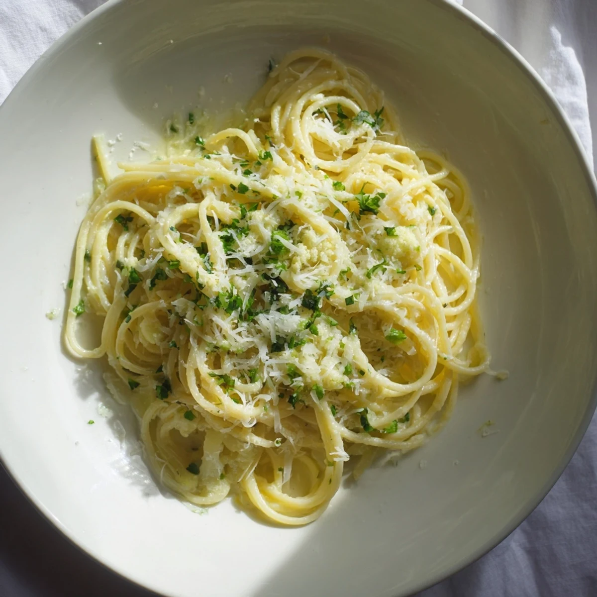 A vibrant bowl of Creamy Roasted Cauliflower Garlic Pasta; pasta glistening in a creamy, flavorful sauce.