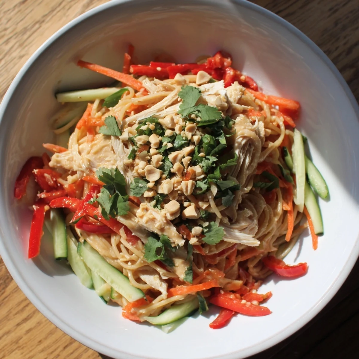 Thai-Inspired Peanut Chicken Pasta, a vibrant salad with chicken, crunchy veggies, and a creamy peanut dressing.