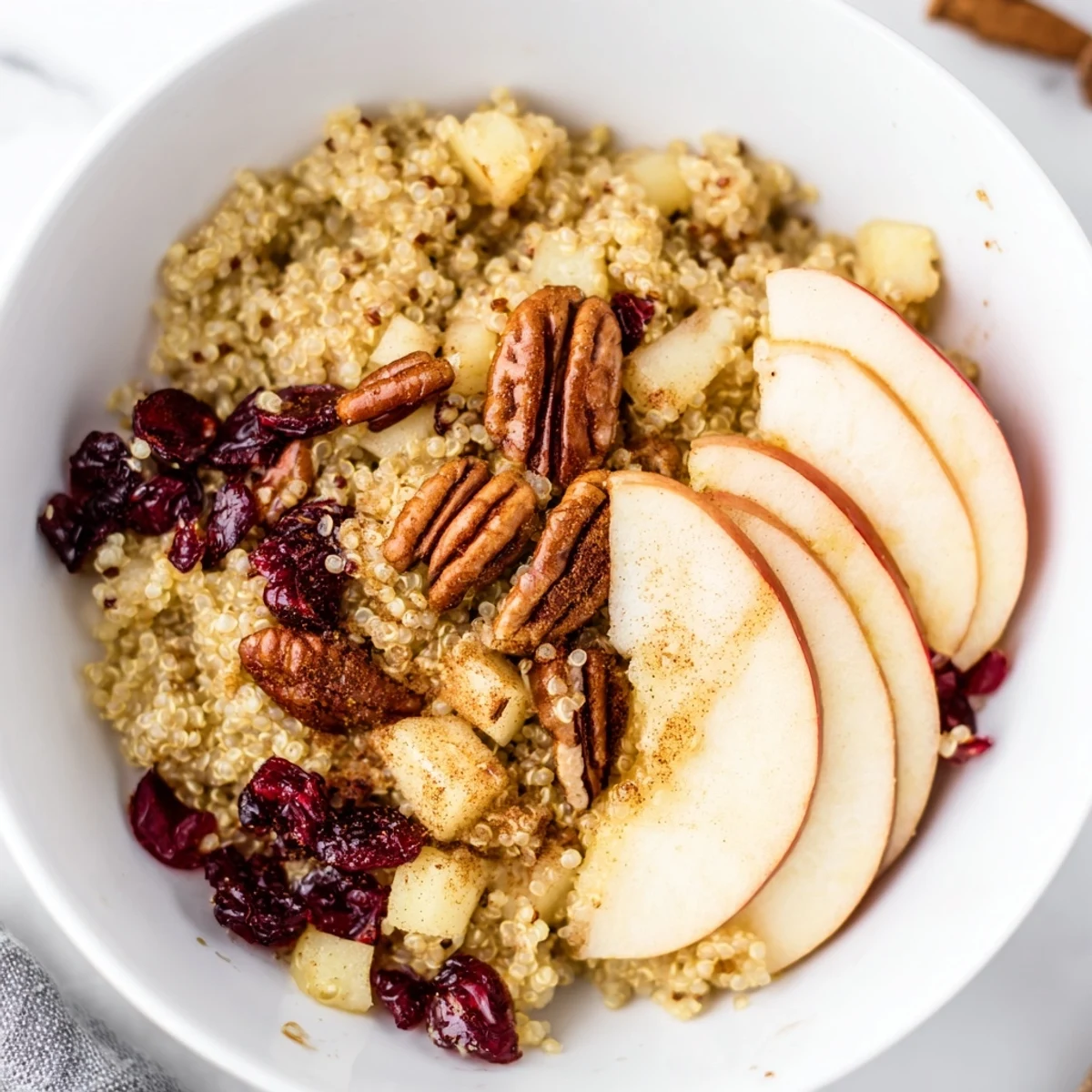 This creamy Apple Cinnamon Quinoa Bowl, brimming with fruit, offers a deliciously comforting start to your day.