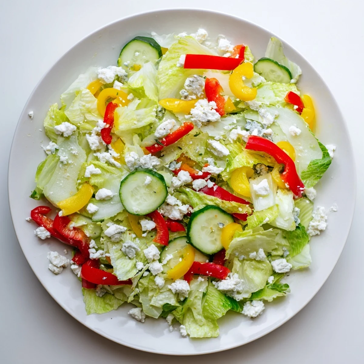 A colorful Bella Hadid Salad brimming with fresh veggies, feta, and lemon dressing, ready to enjoy.