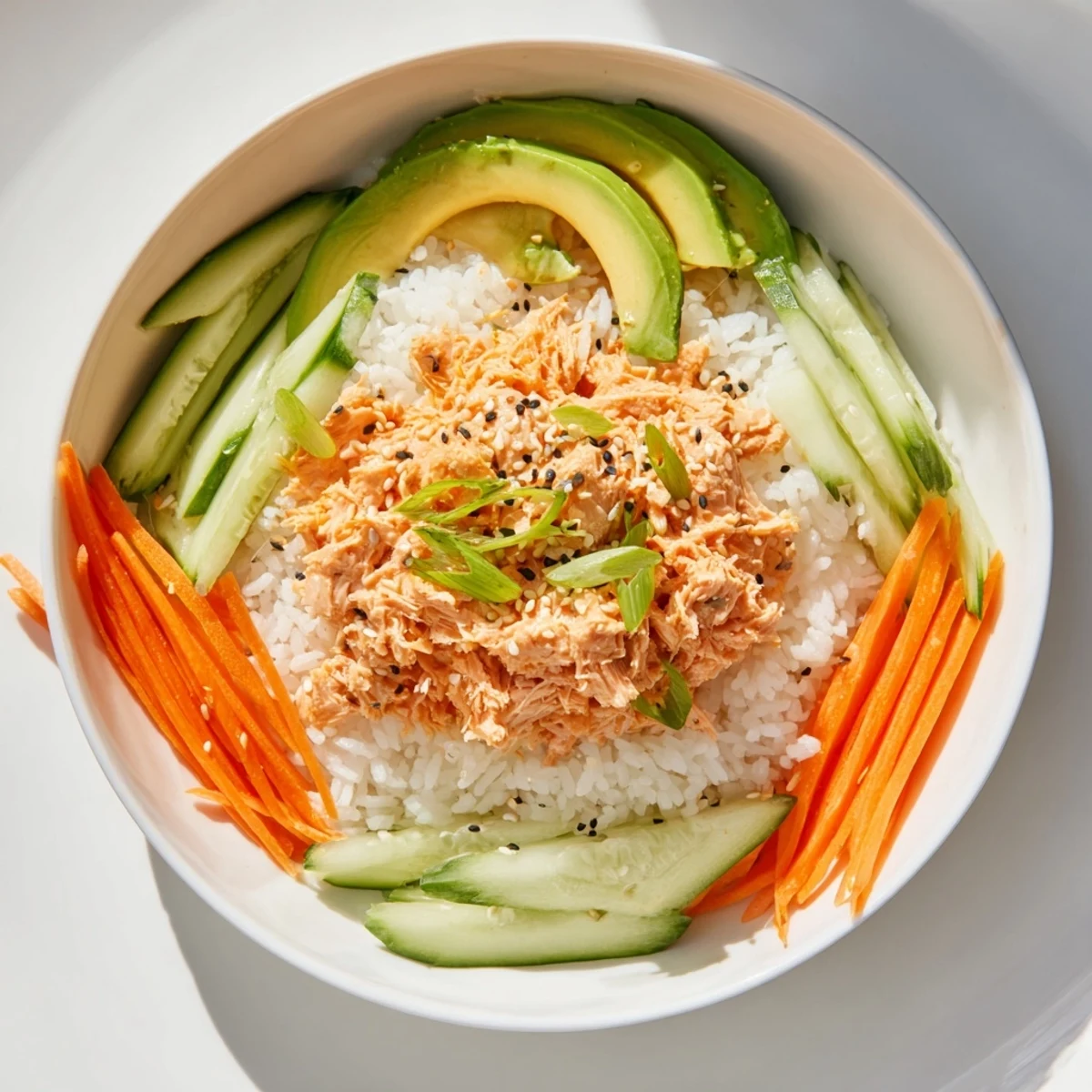 Flaky salmon glistens atop a Spicy Canned Salmon Rice Bowl, a quick and satisfying dinner option.