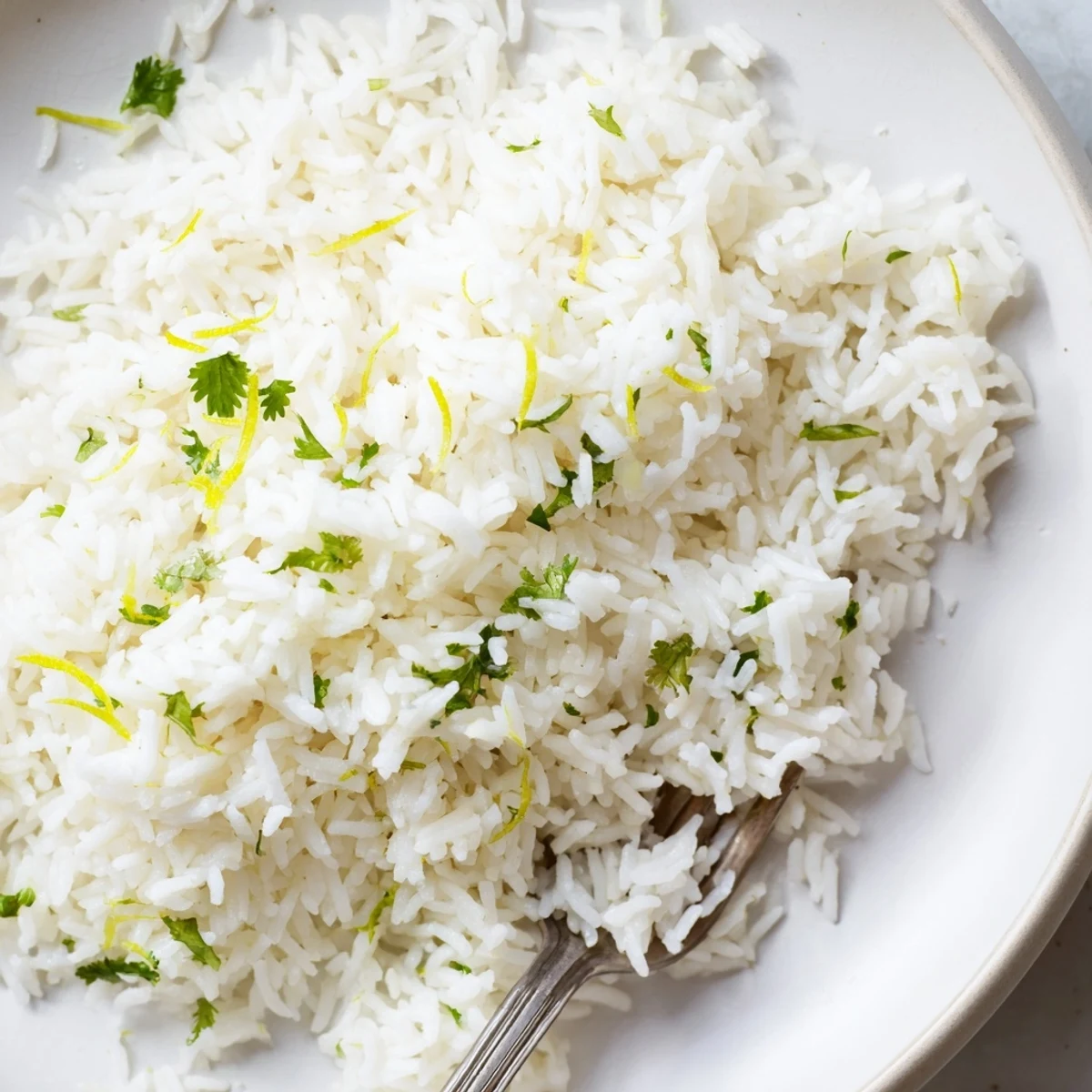 Vibrant green Cilantro Lime Rice, cooked with butter and lime zest, perfect with tacos tonight!