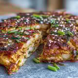 Savory Korean-style kimchi pancakes with crunchy napa cabbage, served hot with a sesame soy dipping sauce.  
