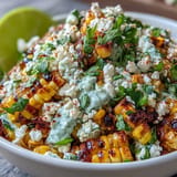 Creamy, tangy Mexican Street Corn Salad dish adorned with fresh, zesty goodness.