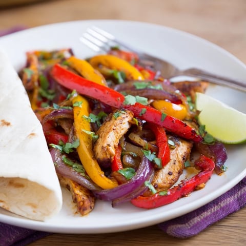 Juicy Sheet Pan Chicken Fajitas with vibrant peppers and onions, perfect for busy nights.  