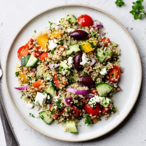 Fresh Mediterranean Quinoa Salad with Feta, vibrant veggies, and zesty dressing.  