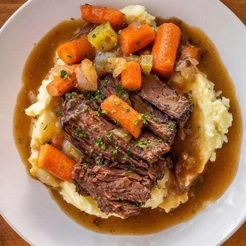 Tender, fall-apart Slow Cooker Pot Roast with vibrant vegetables and creamy mashed potatoes.