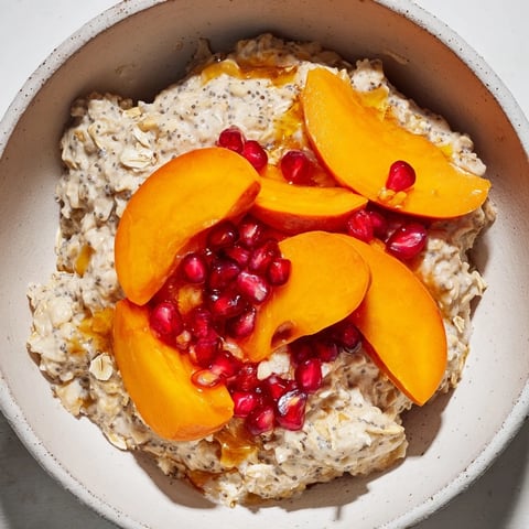 A close-up of creamy Overnight Oats with Persimmon, pomegranate, and chia seeds for a delicious breakfast.