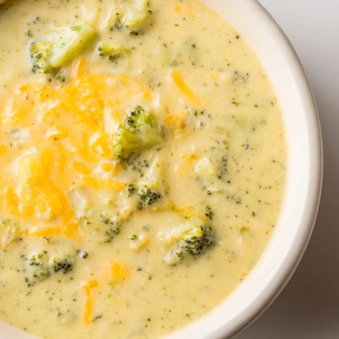 Steaming bowl of Broccoli Cheese Soup with melted cheese, perfect for a comforting weeknight dinner.