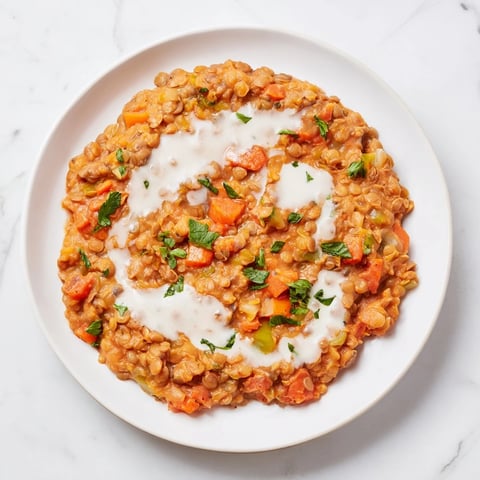 Creamy Tomato Basil Lentil Bolognese, a rich, vibrant vegan pasta topping with fresh basil and tomatoes.