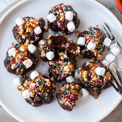 Fudgy, colorful Chaos Chocolate Cake Bites boasting a delightful mix of mini marshmallows and sprinkles.