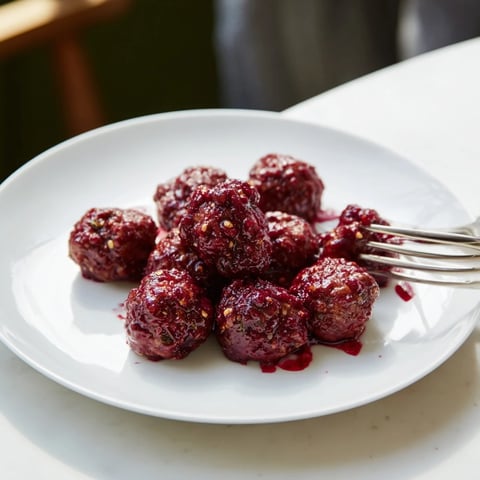 Tender cherry-glazed meatballs glistening with a gorgeous, sweet glaze; perfect party appetizers.
