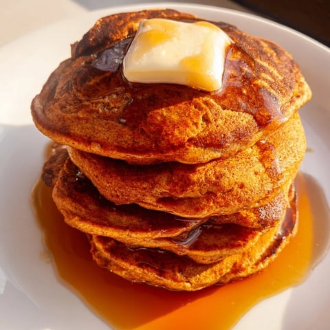 Golden-brown Gingerbread Pancakes, ready to be drizzled with maple syrup for a delicious breakfast.