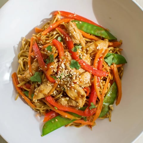 Tender Lemon-Garlic Chicken Stir Fry with Noodles, glistening with savory sauce, ready to serve on a plate.