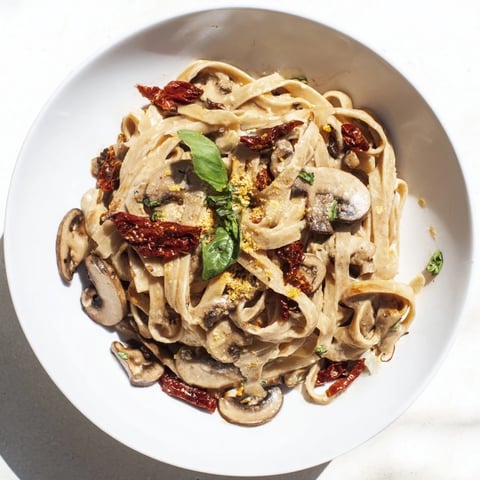 Creamy Vegan Marry Me Mushroom Pasta, a delightful dish with sun-dried tomatoes and fresh basil garnish.