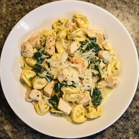 Creamy Chicken and Spinach Tortellini, a rich pasta dish with a creamy Parmesan sauce and tender chicken.
