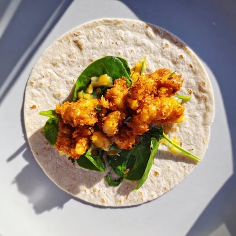 Golden-brown Chicken Piccata Crunch Wrap, a crispy delight filled with tangy lemon sauce and chicken.