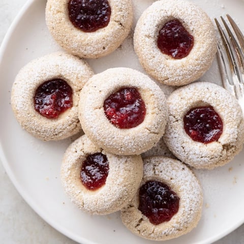 Matcha cranberry shortbread thumbprint cookies, buttery treats with vibrant green matcha and red cranberry filling.