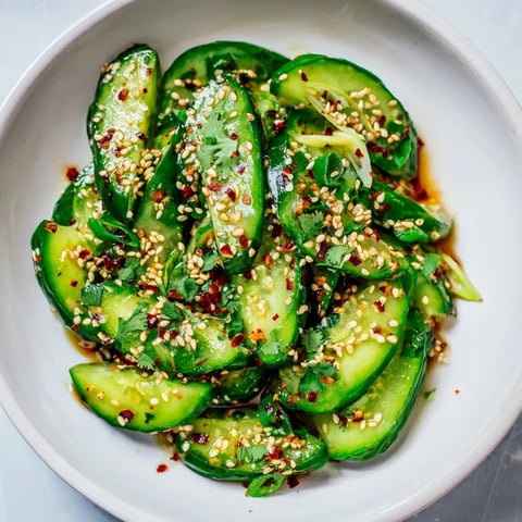 Bright, chilled Zesty Shake Cucumber Salad, with glistening cucumbers and a vibrant, spicy dressing.