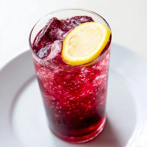 Sleepy Girl Mocktail: A vibrant image of the calming pink drink garnished with a fresh lemon wheel.