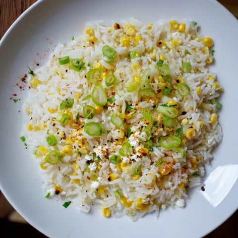Fluffy Mexican Street Corn Rice, bursting with corn, cheese, and zesty lime, a colorful side.