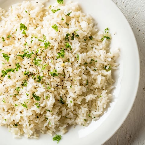Fluffy garlic butter rice, golden and glistening, is a versatile side dish, ready to serve.