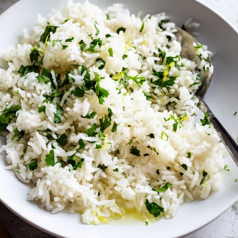 Fluffy Cilantro Lime Rice glistening with fresh lime, ready to serve as a tasty side dish.