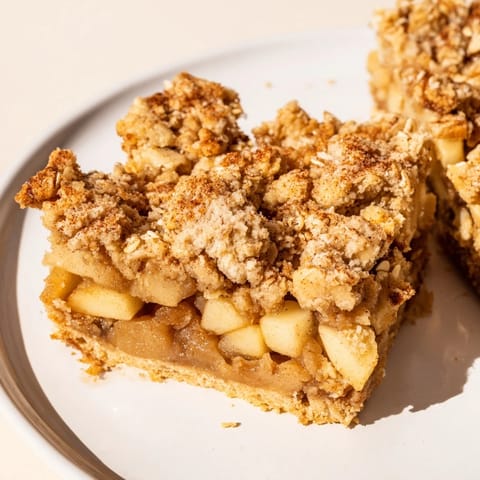 Deliciously spiced Cinnamon Apple Crumble Bars, perfect for cozy gatherings and dessert lovers.  