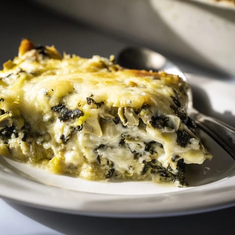 Golden Cheesy Spinach and Artichoke Bake bubbling with melted cheese goodness.  