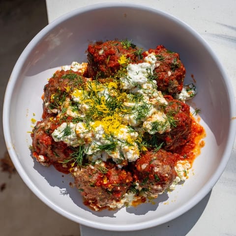 Tender, juicy Instant Pot Greek Meatballs, smothered in vibrant sauce and topped with tangy lemon-feta.