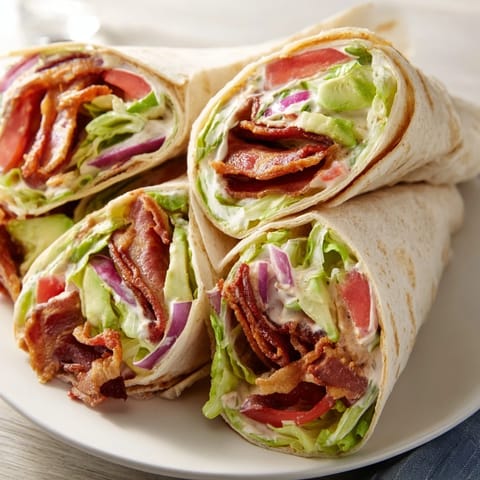 Perfectly constructed Zesty BLT Wraps: soft tortillas filled with bacon, lettuce, tomato, and chipotle mayo for lunch.