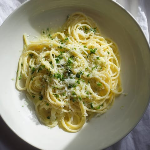A vibrant bowl of Creamy Roasted Cauliflower Garlic Pasta; pasta glistening in a creamy, flavorful sauce.