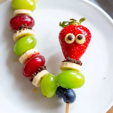 Kid-friendly Caterpillar Fruit Skewer Track showcasing fresh, bright fruit arranged as playful caterpillars.