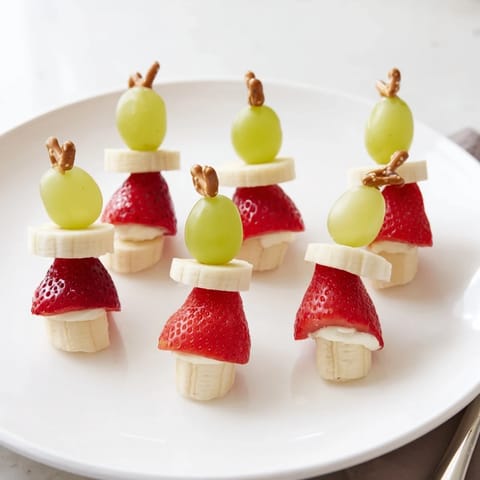 Freshly assembled Strawberry Elf Hat Skewers with cream cheese, making a fun, kid-friendly snack.