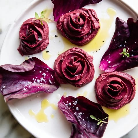 The beautiful Velvet Rose appetizer: creamy beet hummus roses swirled and served with fresh radicchio.
