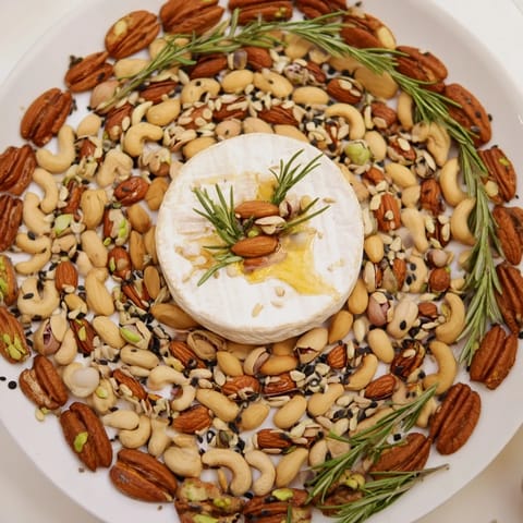 A vibrant photo of "The Labyrinth" appetizer, showcasing a maze of nuts leading to creamy cheese.