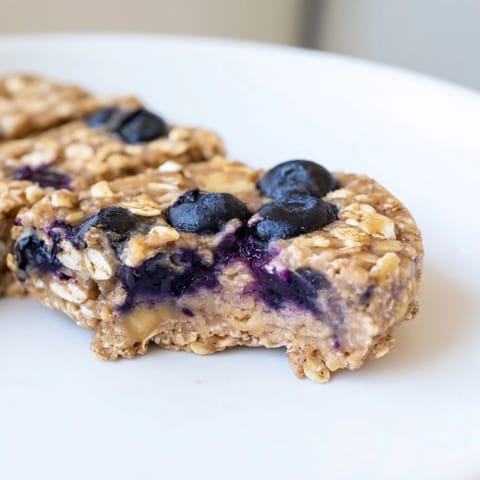 A close-up of delicious Blueberry Banana Oatmeal Protein Bars, ideal as a quick and healthy snack.