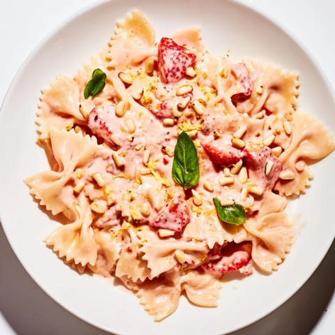 Close-up shot of the finished Strawberry Sour Cream Pasta, showcasing juicy strawberries and inviting, fresh flavors.