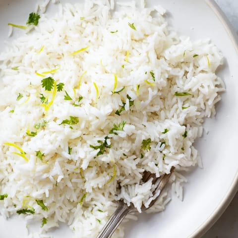 Vibrant green Cilantro Lime Rice, cooked with butter and lime zest, perfect with tacos tonight!
